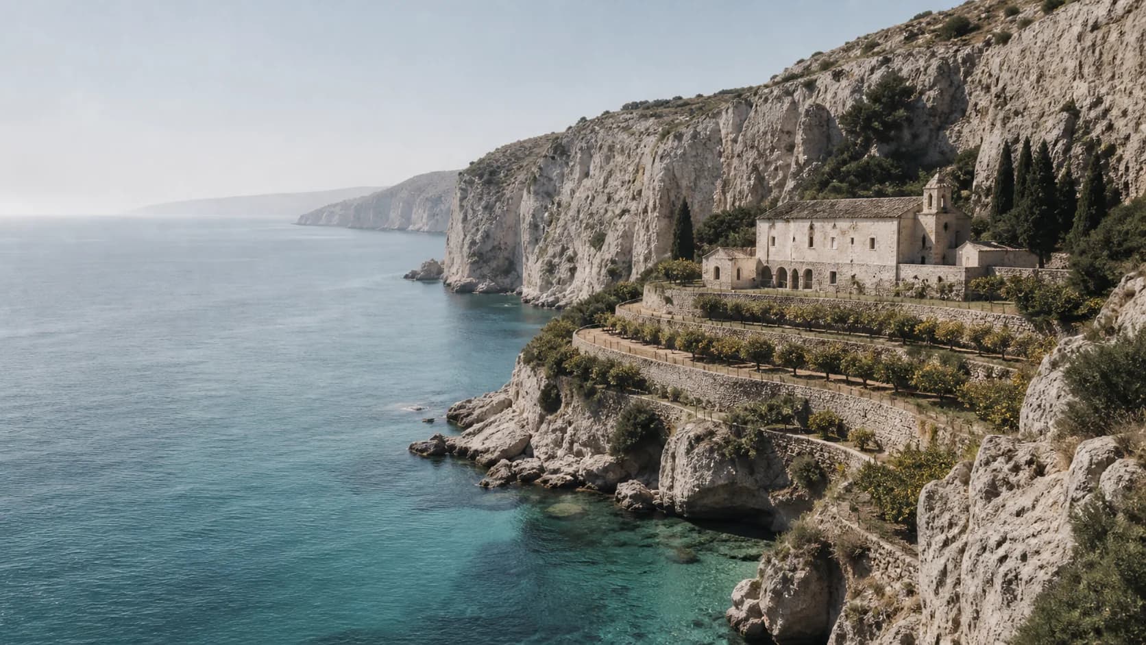 Clear midday water below the limestone cliffs of the Calanera coast.