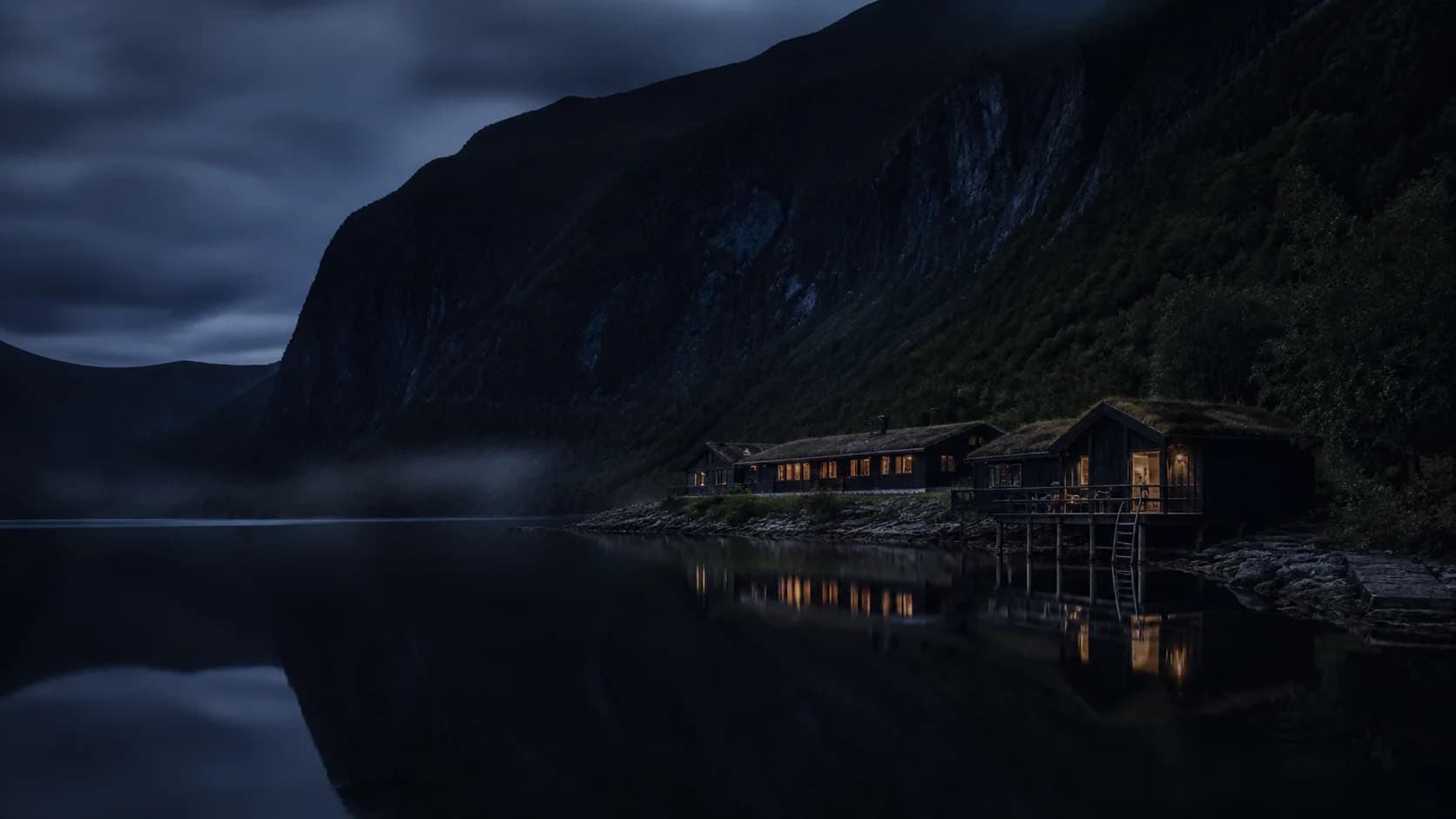 Night over Lindhavn fjord, mountains barely visible above still black water.
