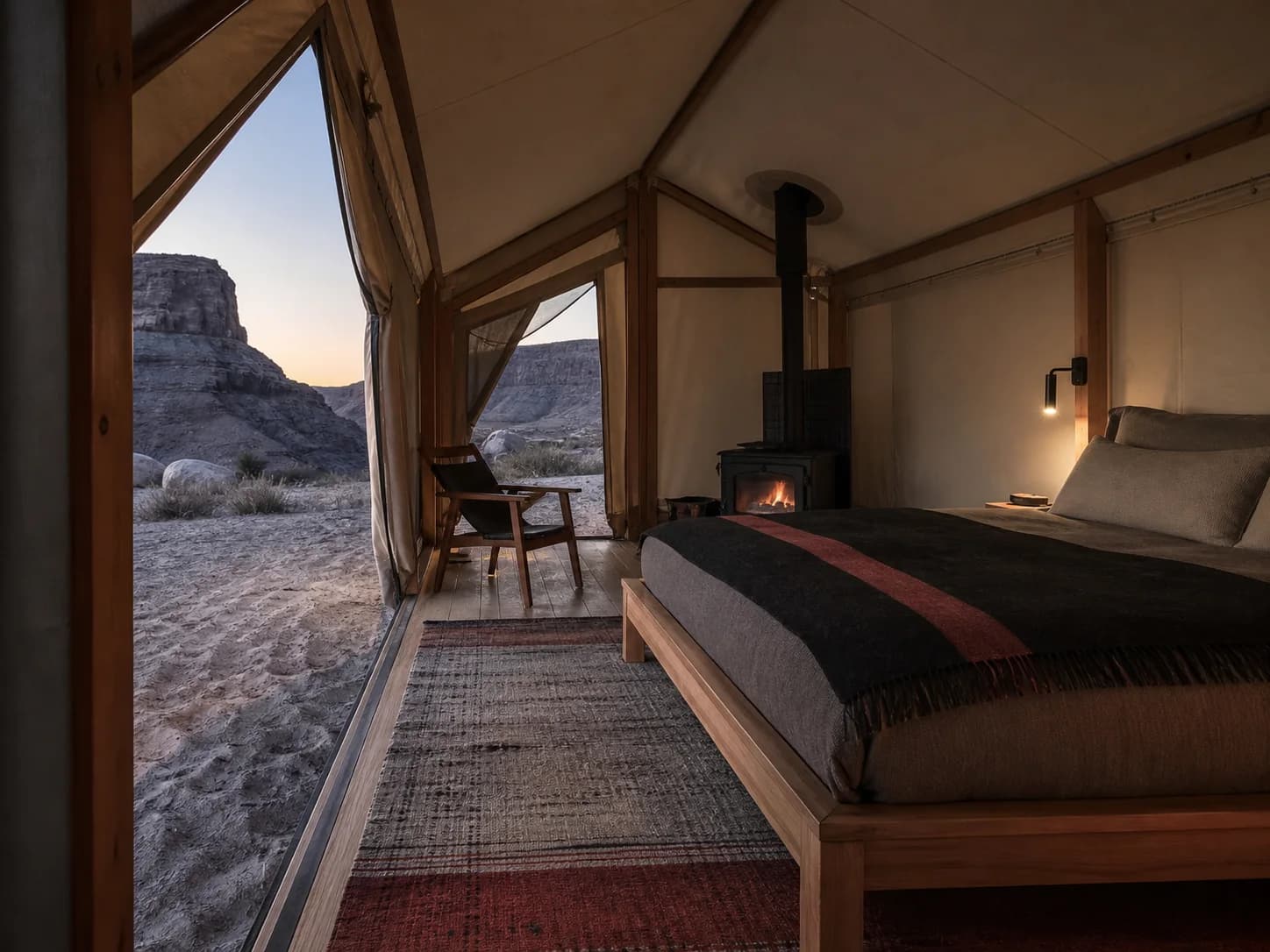 An Escarpment Tent at Montreval Sabaia, canvas walls open toward the rock face at dawn.